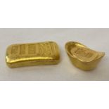 2 Chinese gold coloured metal Yuabao wealth ingots, with impressed Chinese markings and symbols.