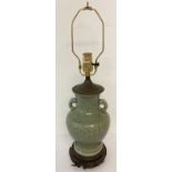 A Chinese celadon glazed, 2 handled lamp base with floral design and brass light fitting.