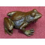 A small Japanese bronze figurine of a frog.