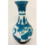 A Chinese Peking glass vase. Petrol blue carved overlay decorated with cranes and leaves.