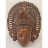 A Balinese carved wall hanging head plaque.