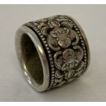 A Chinese white metal Archers ring with decorative central rotating panel featuring fu bat.