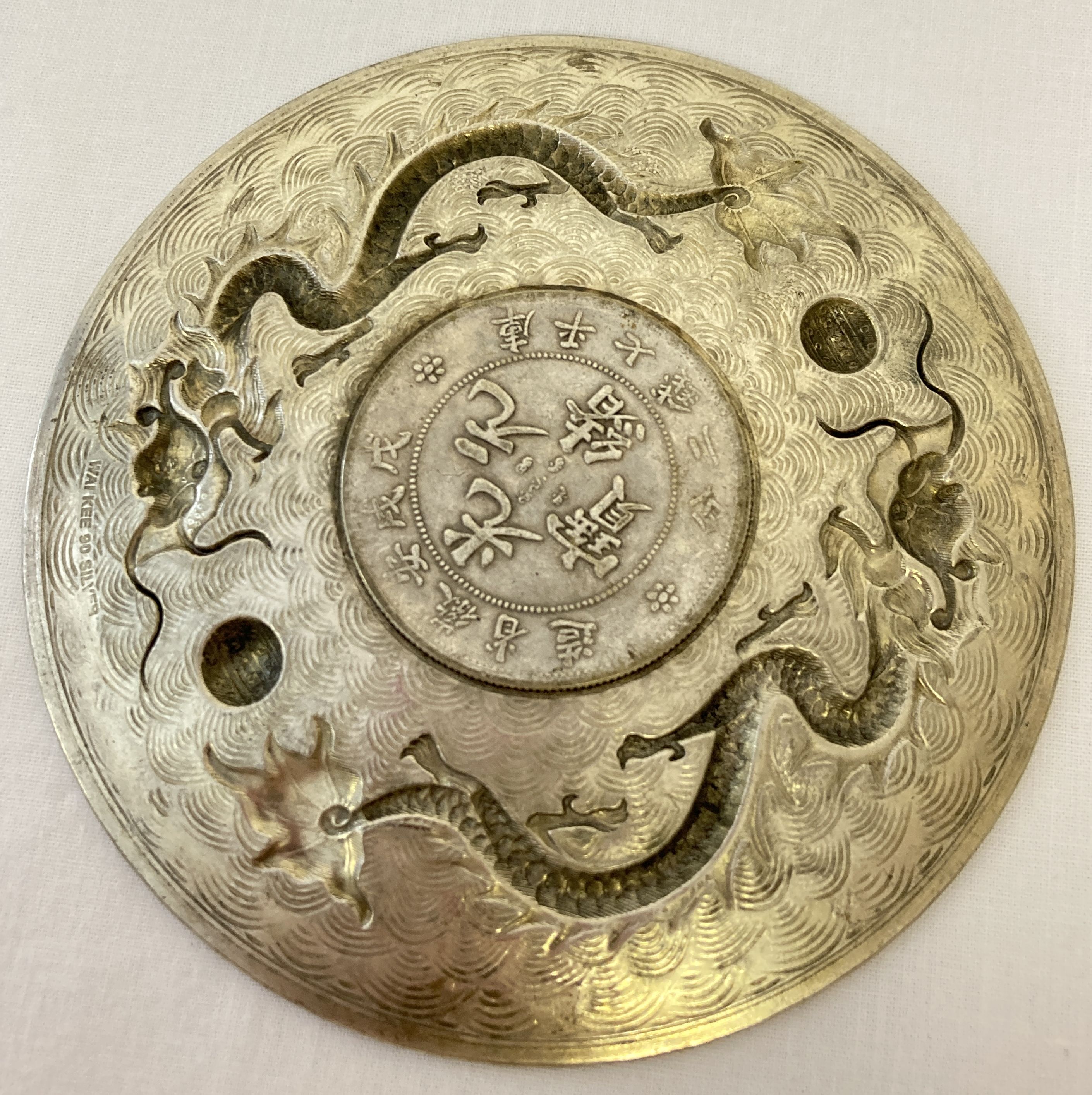 A Chinese white metal coin dish, made from central coin with white metal surround featuring dragons. - Image 2 of 3