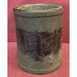 A heavy bronze brush pot with calligraphy detail.