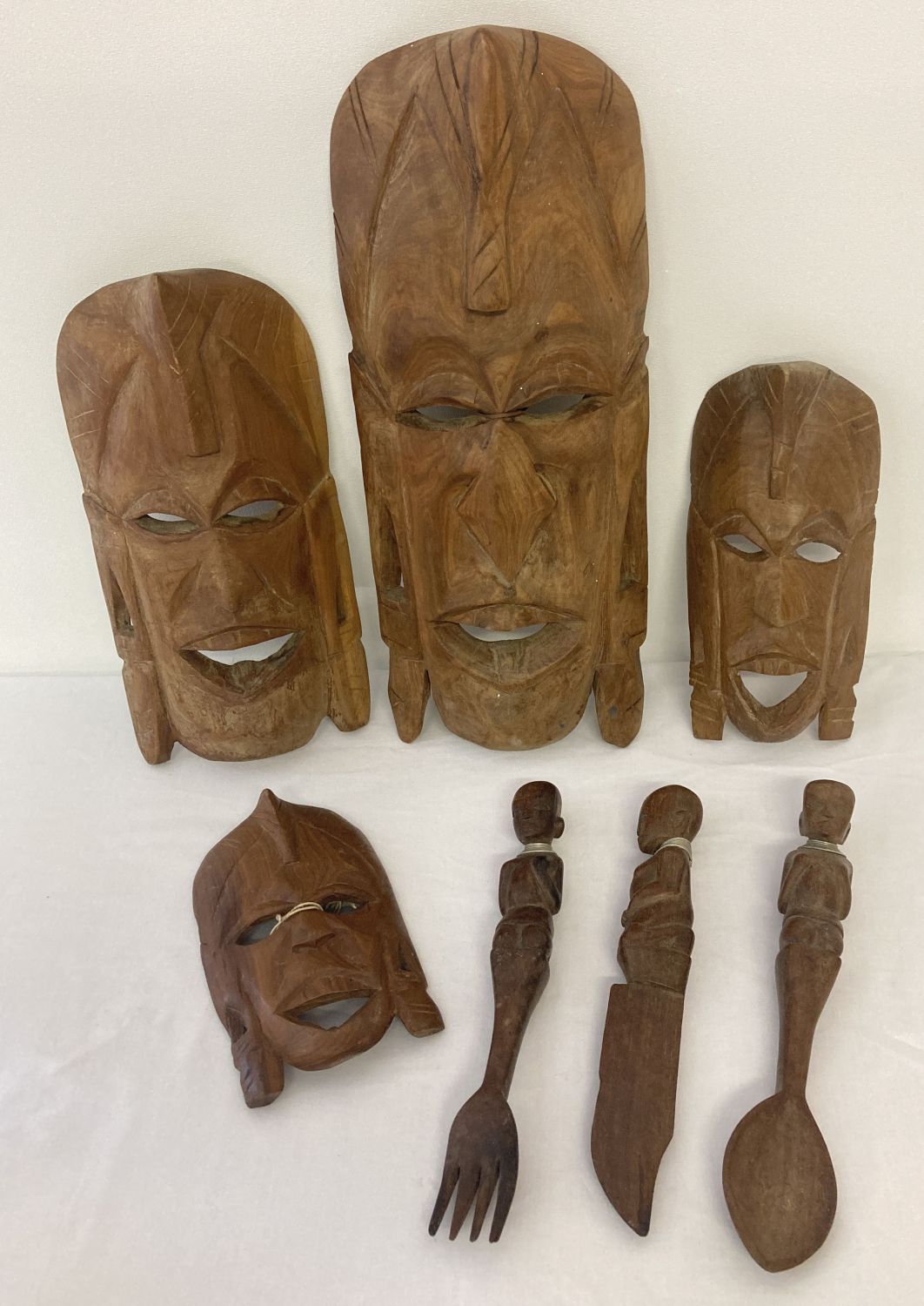 A collection of African carved wooden tribal items.