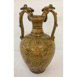 A ceramic 2 handled urn with yellow/brown glaze and hand painted dragon detail.