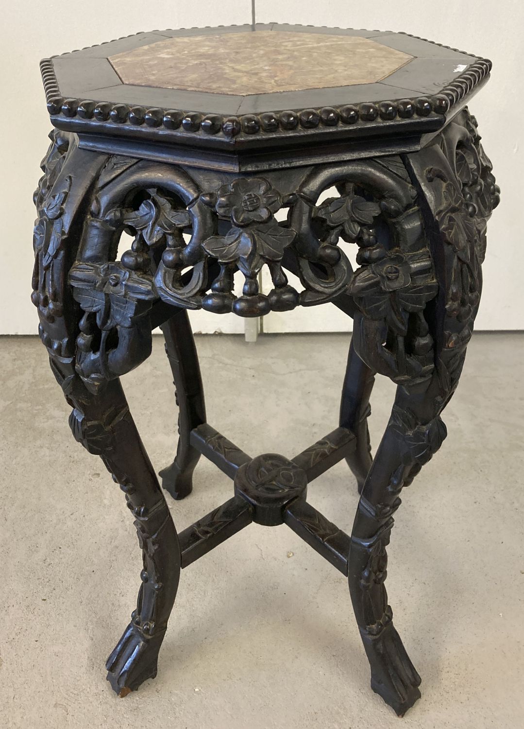 A Chinese carved hardwood octagonal topped plant stand.