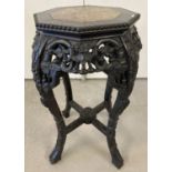 A Chinese carved hardwood octagonal topped plant stand.