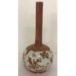 A small oriental vase with floral and bird decoration, in orange and gilt colours.