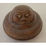 A small circular wooden Japanese trinket pot with carved figural detail to top.