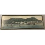 A framed and glazed silk style fabric picture depicting a Chinese harbour scene.