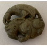 A Chinese Jade roundel depicting Mythical creatures. Carved detail to both side.