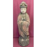 A large carved wooden figurine of an Oriental deity with painted detail.