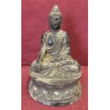 A small circular based hollow bronze figure of seated Buddha.