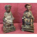 2 small carved wooden Oriental painted figures, one with indistinct symbols to the back.