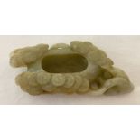 A carved jade brush washer with cherry blossom detail.