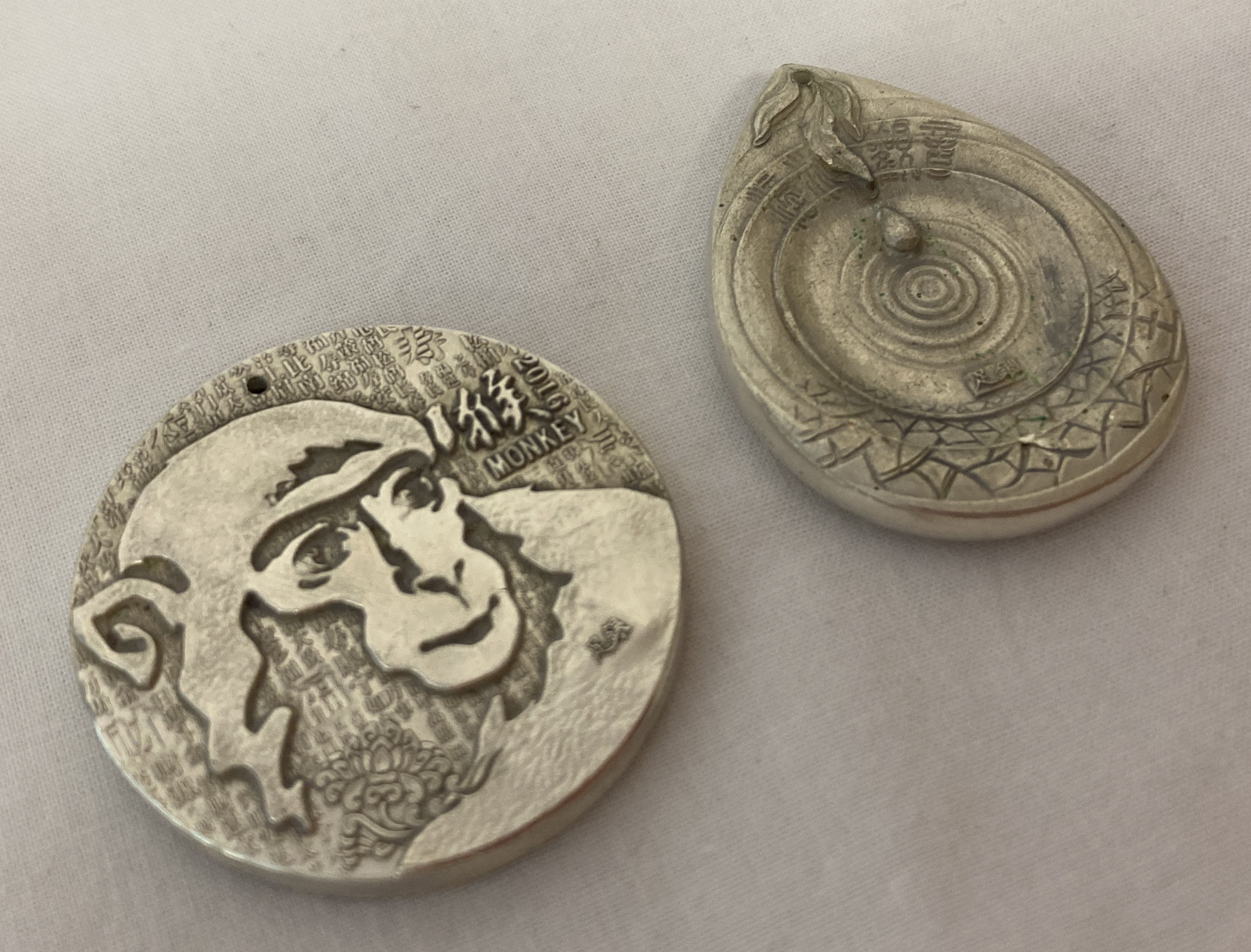 2 Chinese white metal, double sided pendants depicting Oriental Deities. - Image 2 of 2