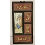 A Chinese wooden framed screen housing a signed porcelain panel with figural detail.