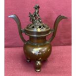 A decorative lidded bronze censer with gold splash detail.