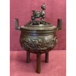 A Chinese bronze lidded censer with pierced work detail to lid and foo dog finial.