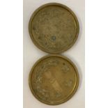 2 Chinese brass circular shaped dishes with dragon detail and Chinese symbols.