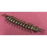A small bronze figure of a fully articulated centipede.