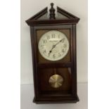 A Daniel Dakota dark wood cased, wall hanging Westminster Chime wall clock.