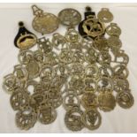 A collection of 40 + vintage horse brasses and 2 small trivets.