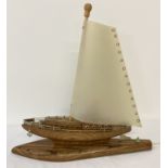 A vintage Mid Century wooden boat shaped table lamp with shade.