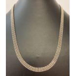 A decorative flat bead design silver chain necklace with lobster style clasp, approx. 18".