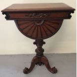 A mahogany Regency style Teapoy raised on decorative tripod feet.