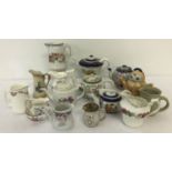 A box of assorted vintage and Victorian ceramic miniature teapots and jugs.