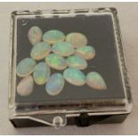 A collection of 14 oval and teardrop shaped cut opals ready for jewellery making.