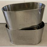 A pair of very large Bollinger Champagne buckets with engraved details to sides.