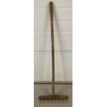 A vintage wooden rake.