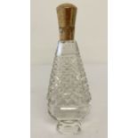 A cut glass scent bottle with gold hinged lid.