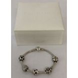 A silver Pandora charm bracelet with 5 charms.