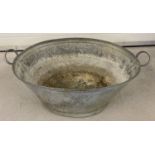 A vintage oval shaped 2 handled galvanised bath.