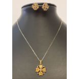 A matching flower design necklace and earrings set with citrine coloured stones.