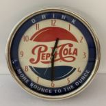 A modern wall hanging, battery operated Pepsi Cola advertising clock.