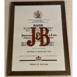 A wooden framed advertising mirror for J & B blended scotch whiskey.