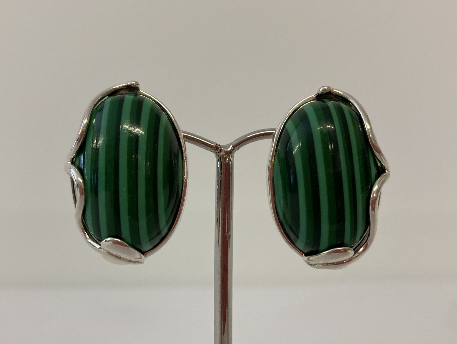 A pair of 925 silver clip on earrings set with green striped stone, in an Art Nouveau style setting.