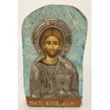 A hand painted Russian icon faced with white metal detail.