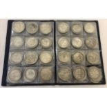 A folder containing 72 assorted white metal coins from around the world.