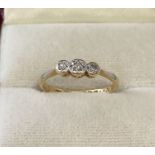 A vintage 18ct gold and platinum diamond set trilogy ring.