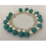 A white metal, turquoise and pearl bracelet with lobster clasp.