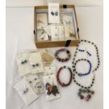 A collection of costume jewellery to include matching necklace, bracelet and earrings set.