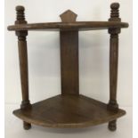 A vintage medium oak 2 tier corner shelf with turned detail to columns.