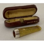 A silver mounted amber effect cigarette holder, hallmarked Birmingham 1918.