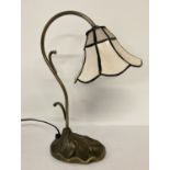 A small Tiffany style table lamp with floral decoration to base.